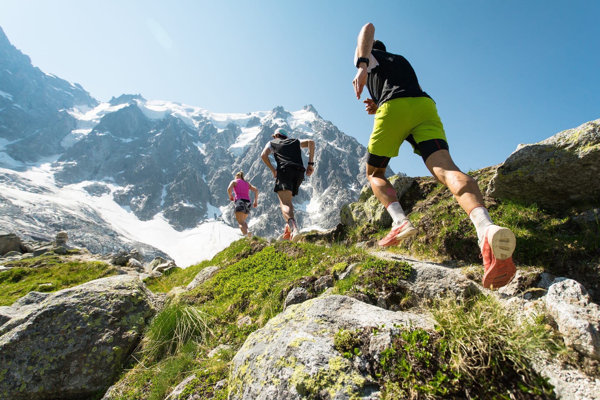 Trail runners moving along an alpine ridge